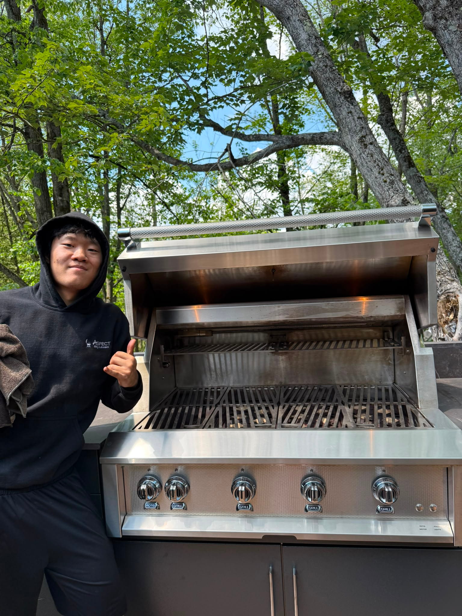 Aspect crew member with a freshly cleaned built-in grill